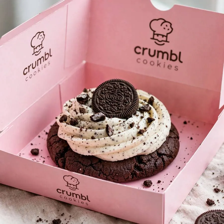 Cookies and Cream Crumbl Cookie served in a pink bakery box
